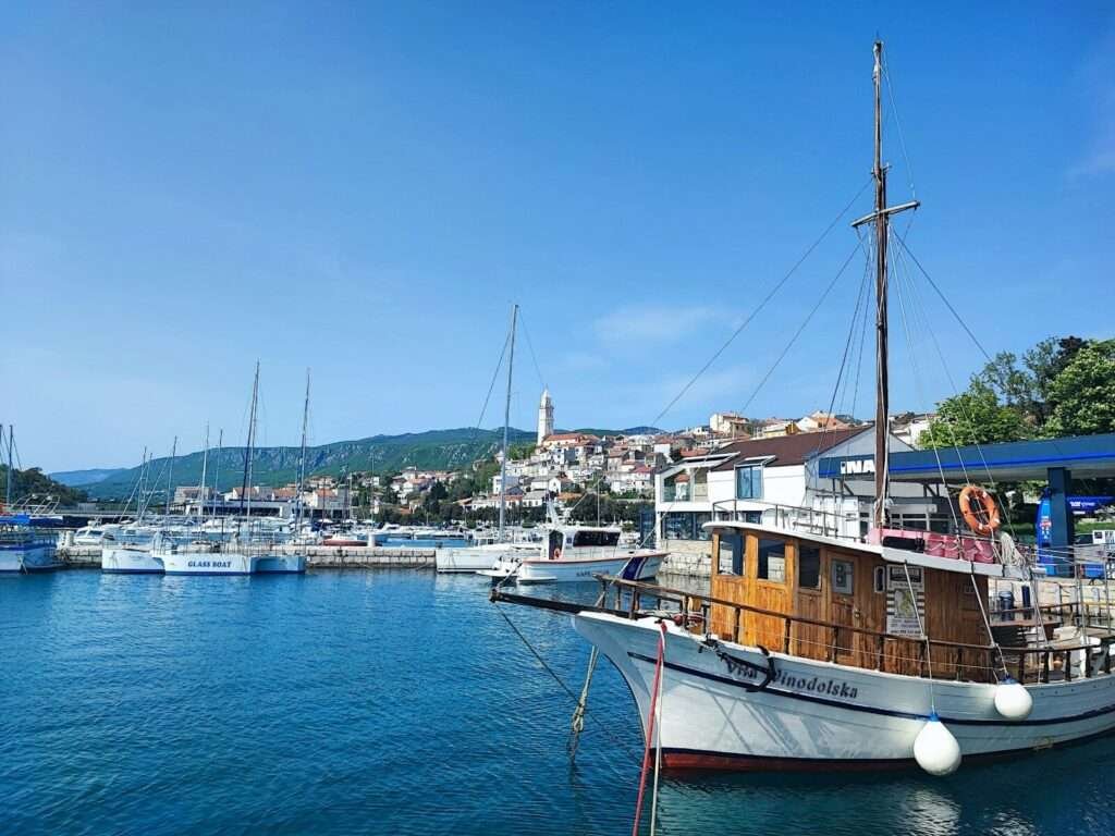 Boats docked in a harbor on a sunny day.